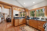 Kitchen has beautiful wood cabinets, granite counters, and stainless appliances
